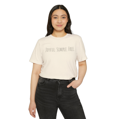 a person wearing jeans and a white t-shirt with the words joyful.simple. free printed on it